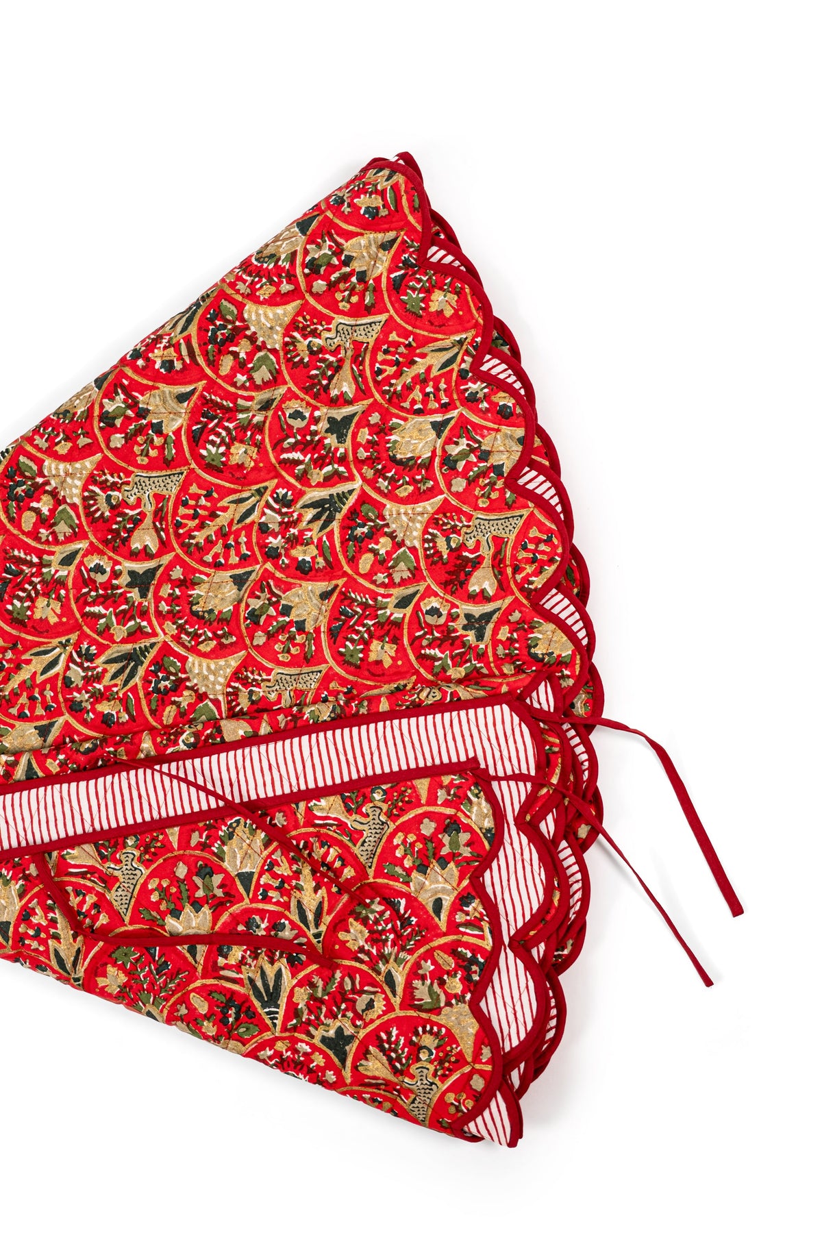 Close-up of Red Holiday Arch tree skirt print with scalloped edge and striped binding