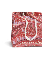 Close-up of medium Florentine pink hand marbled gift bag with white rope handle