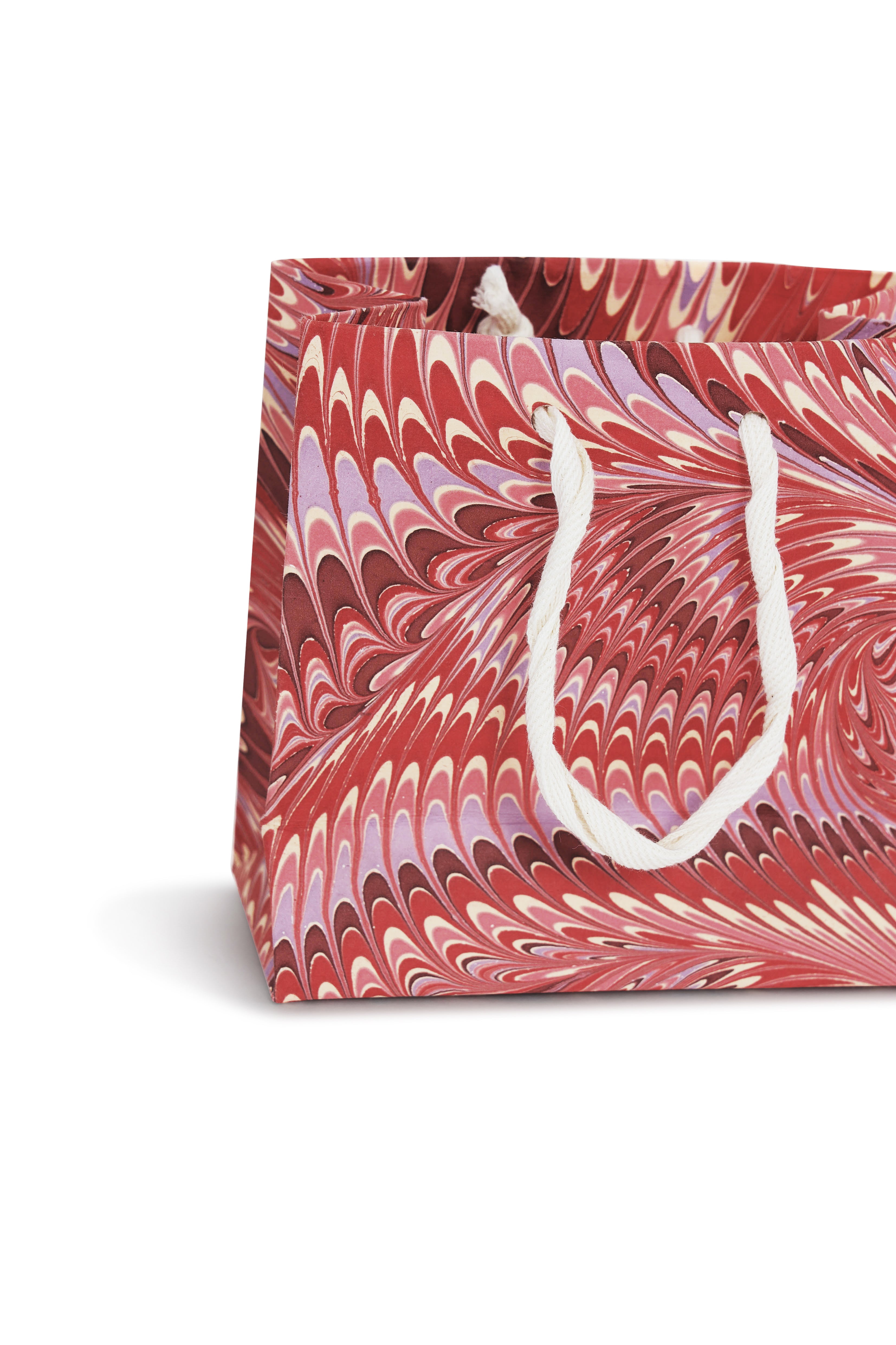 Close-up of medium Florentine pink hand marbled gift bag with white rope handle
