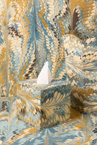 Hand-marbled tissue box covers in gold-blue feather patterns from Inner Child