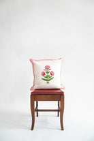Pink poppy blockprint decorative pillow on wooden chair