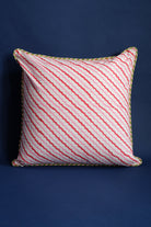 Decorative pillow with pink/red striped pattern and green trim detail
