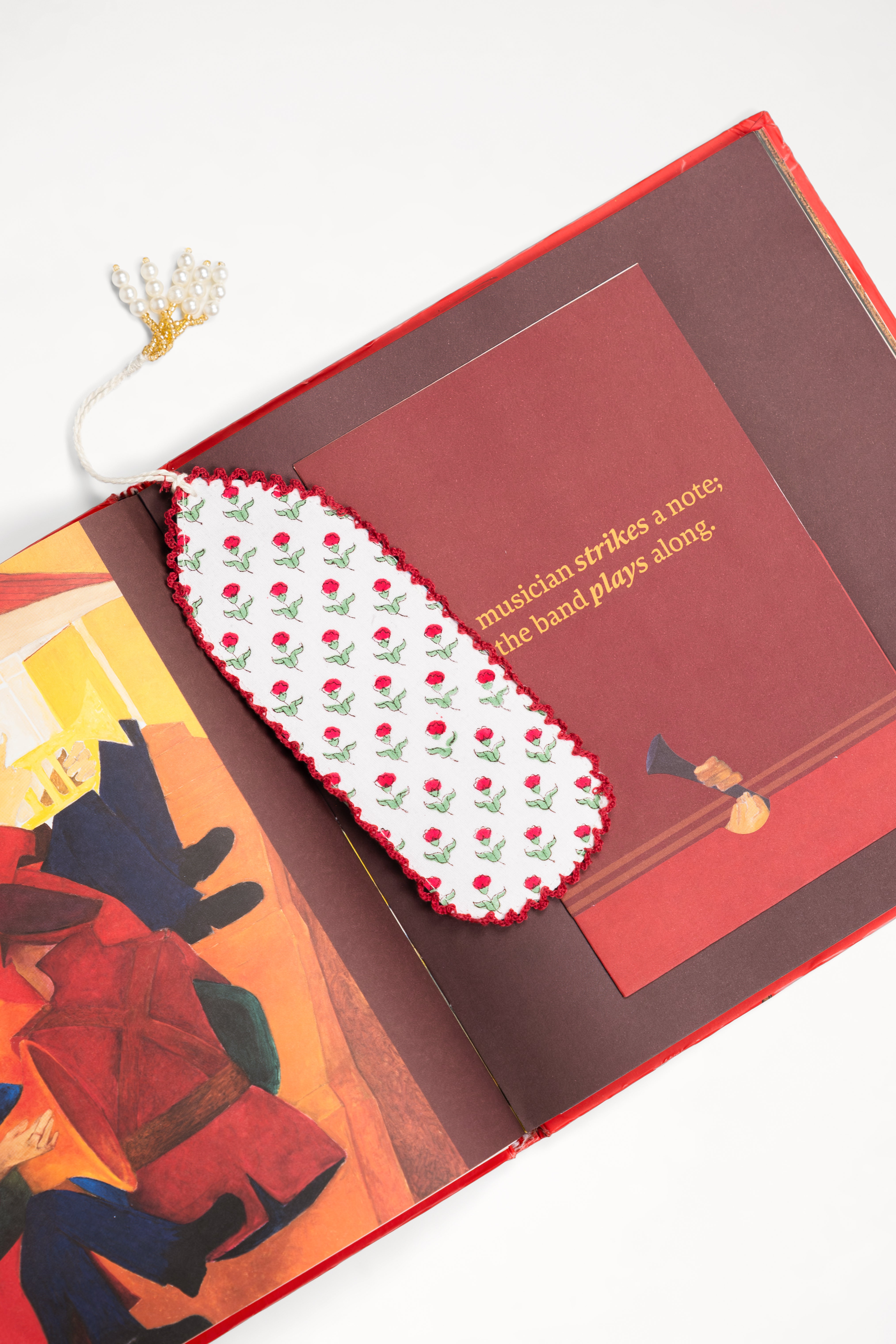 Red primrose blockprint bookmark in open illustrated book