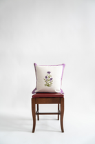 Purple botanical study blockprint pillow on wooden chair