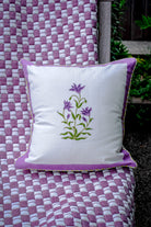 Purple botanical study blockprint pillow on woven quilt outdoor