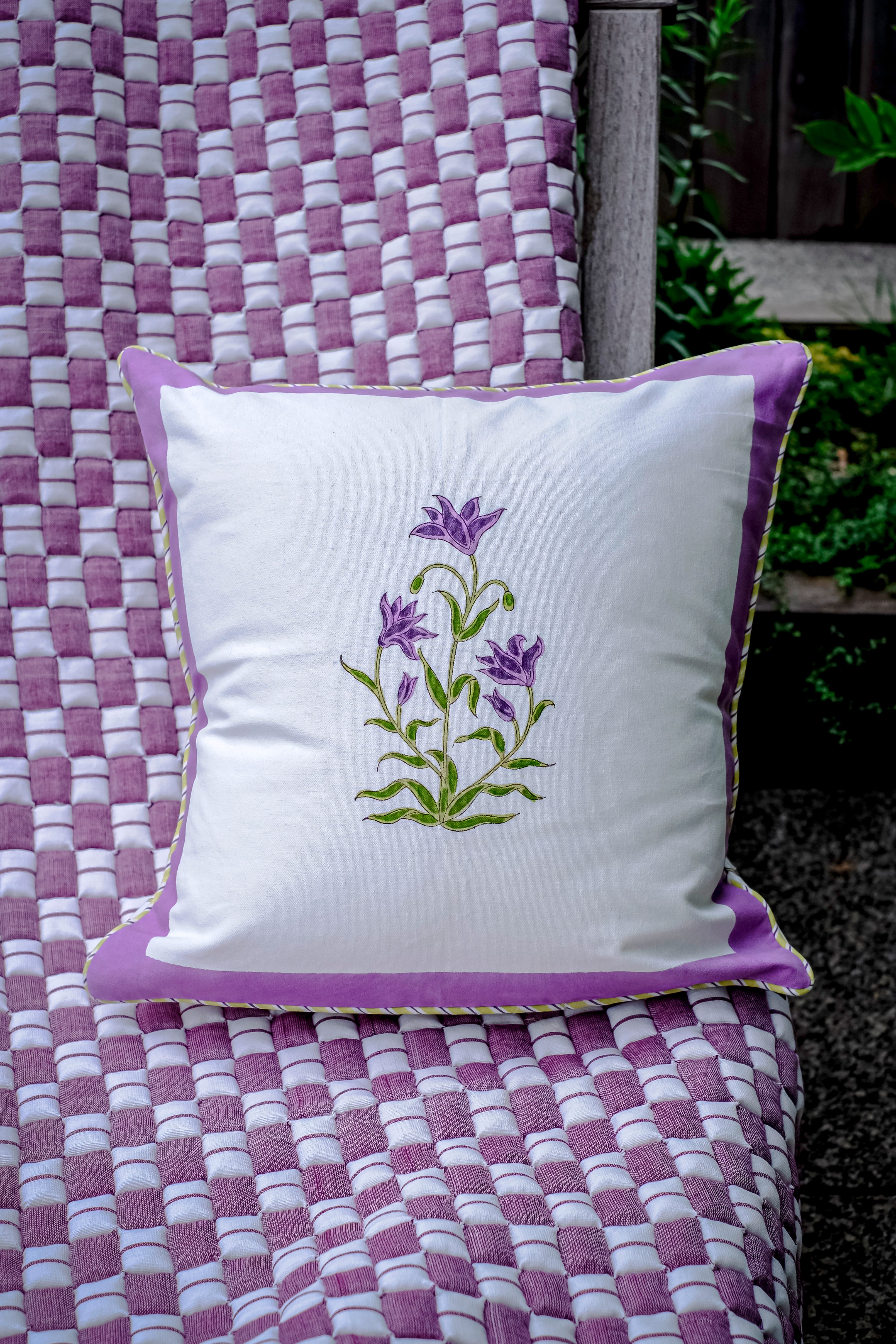 Purple botanical study blockprint pillow on woven quilt outdoor
